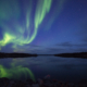 Northern lights reflecting in lake in September. Yellownkife Canada